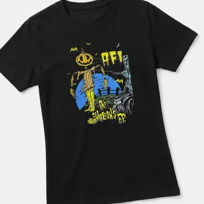 Graphic illustration of a scarecrow with a pumpkin head and bold text. — printed on a women's shirt