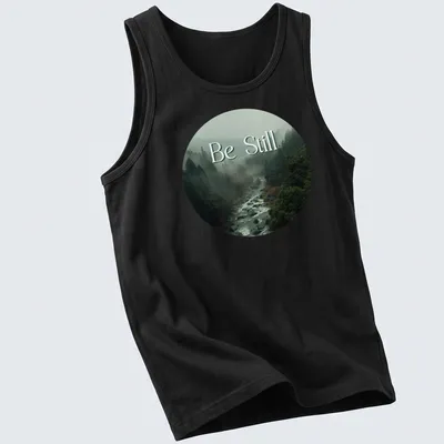 Misty forest scene with 'Be Still' text in earthy tones — printed on a tank top