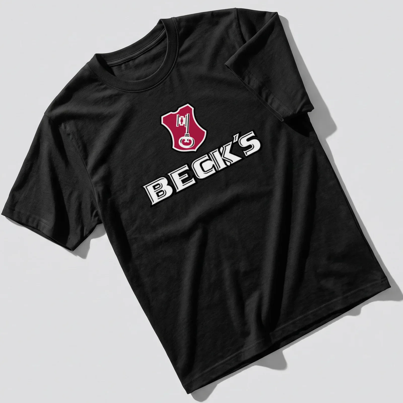 Emblem design with Beck's logo and a key graphic in red, black, and white — printed on a unisex t-shirt
