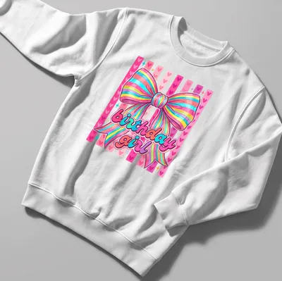 Cute coquette t-shirt with colorful rainbow bow and birthday girl text — printed on a unisex sweatshirt