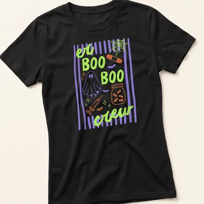 Playful cartoon design of a ghost, medical elements, and bats with 'er BOO BOO crew' text — printed on a women's shirt