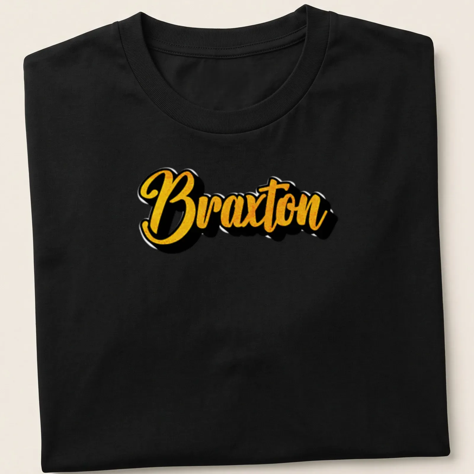 Personalized t-shirt featuring the name Braxton in bold yellow script on black. — printed on a unisex t-shirt