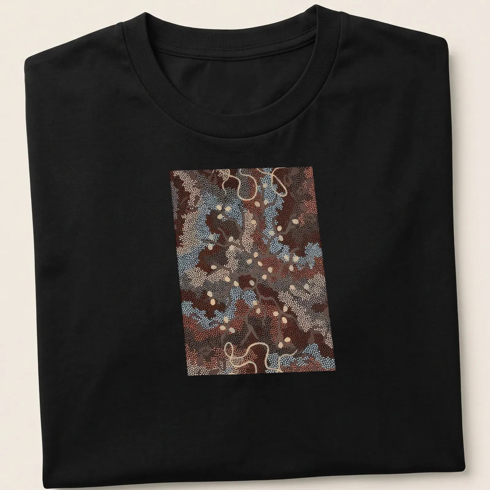 Abstract nature patterns in dot painting style with 'Bush Tucker Dreaming' text. — printed on a unisex t-shirt