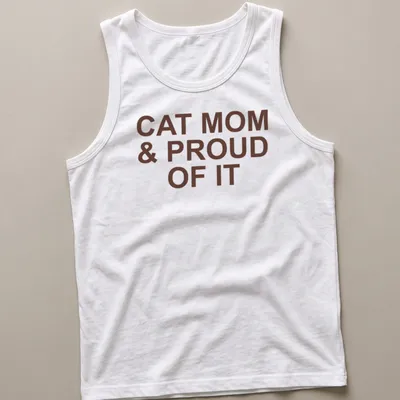 Bold typography of 'Cat Mom & Proud Of It' on a brown — printed on a tank top