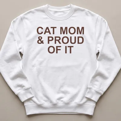 Bold typography of 'Cat Mom & Proud Of It' on a brown — printed on a unisex sweatshirt