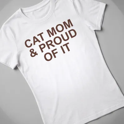 Bold typography of 'Cat Mom & Proud Of It' on a brown — printed on a women's shirt