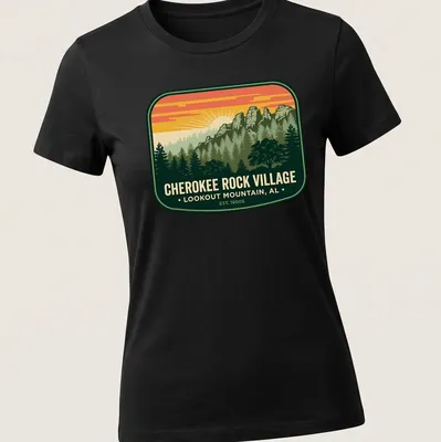 Vintage badge tee with mountain landscape and trees in green, orange, yellow, and blue — printed on a women's shirt