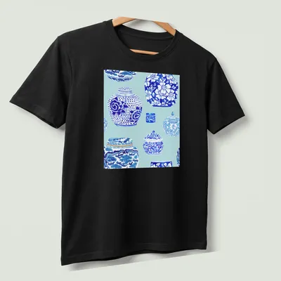 Watercolor print of elegant ginger jars in ice blue tones — printed on a unisex t-shirt (angled view)