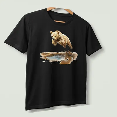 Watercolor graphic of a cute bear cub jumping over water — printed on a unisex t-shirt (angled view)