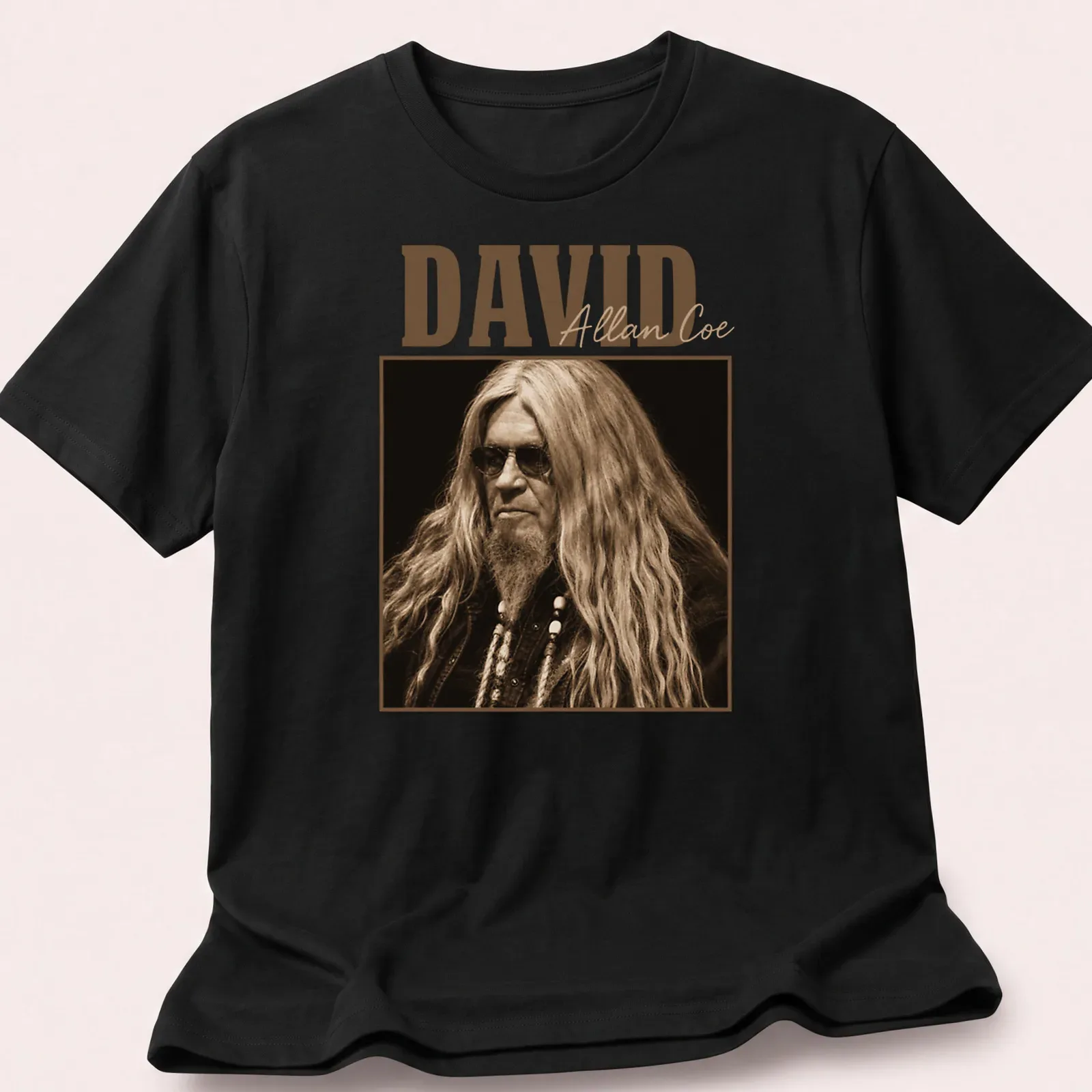 Vintage David Allan Coe t-shirt with distressed typography in brown and beige — printed on a unisex t-shirt