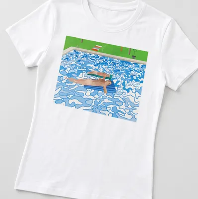 Colorful modern print of swimmers enjoying a pool with blue, green, orange, and brown hues — printed on a women's shirt