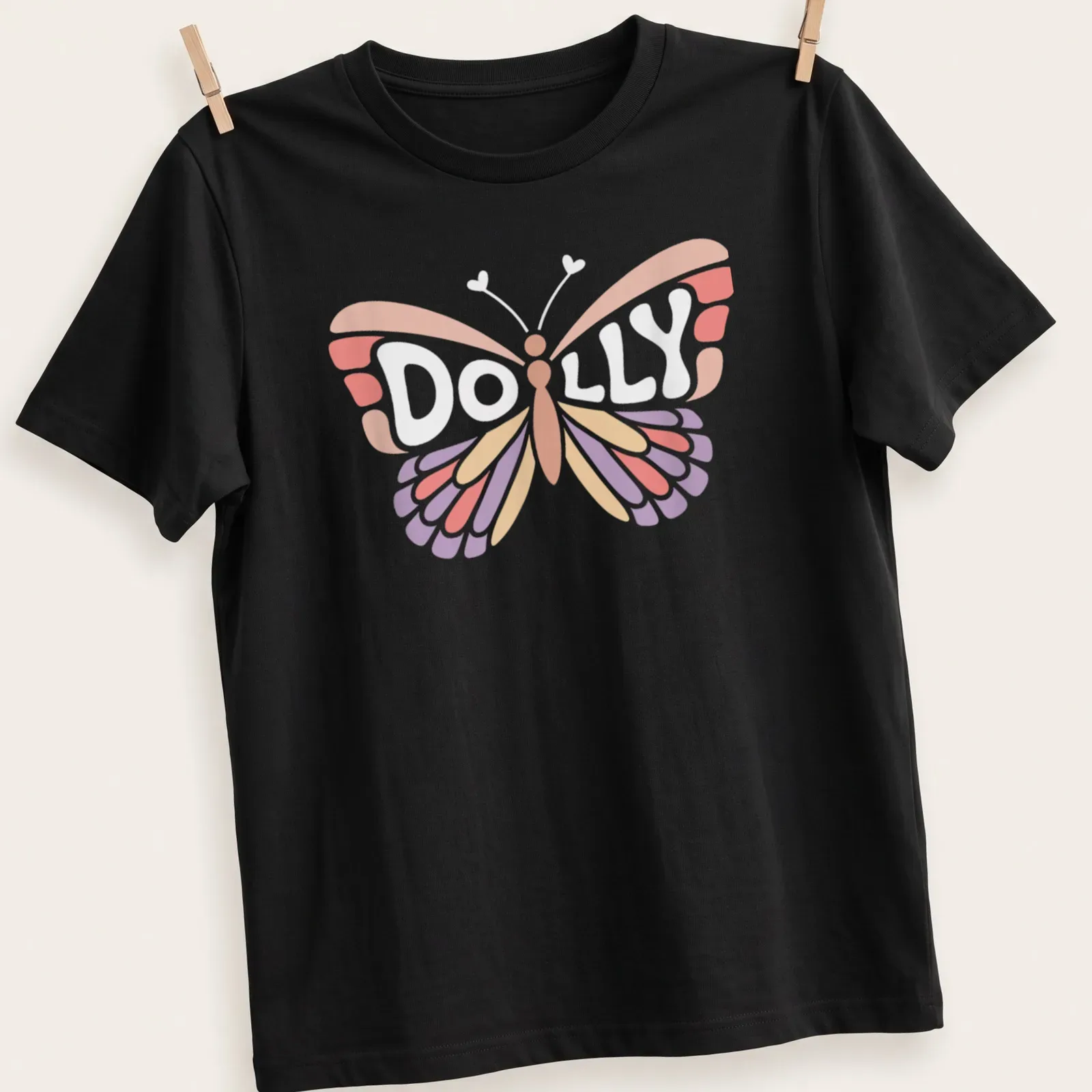 Cute vintage style t-shirt with the name Dolly and a butterfly design — printed on a unisex t-shirt