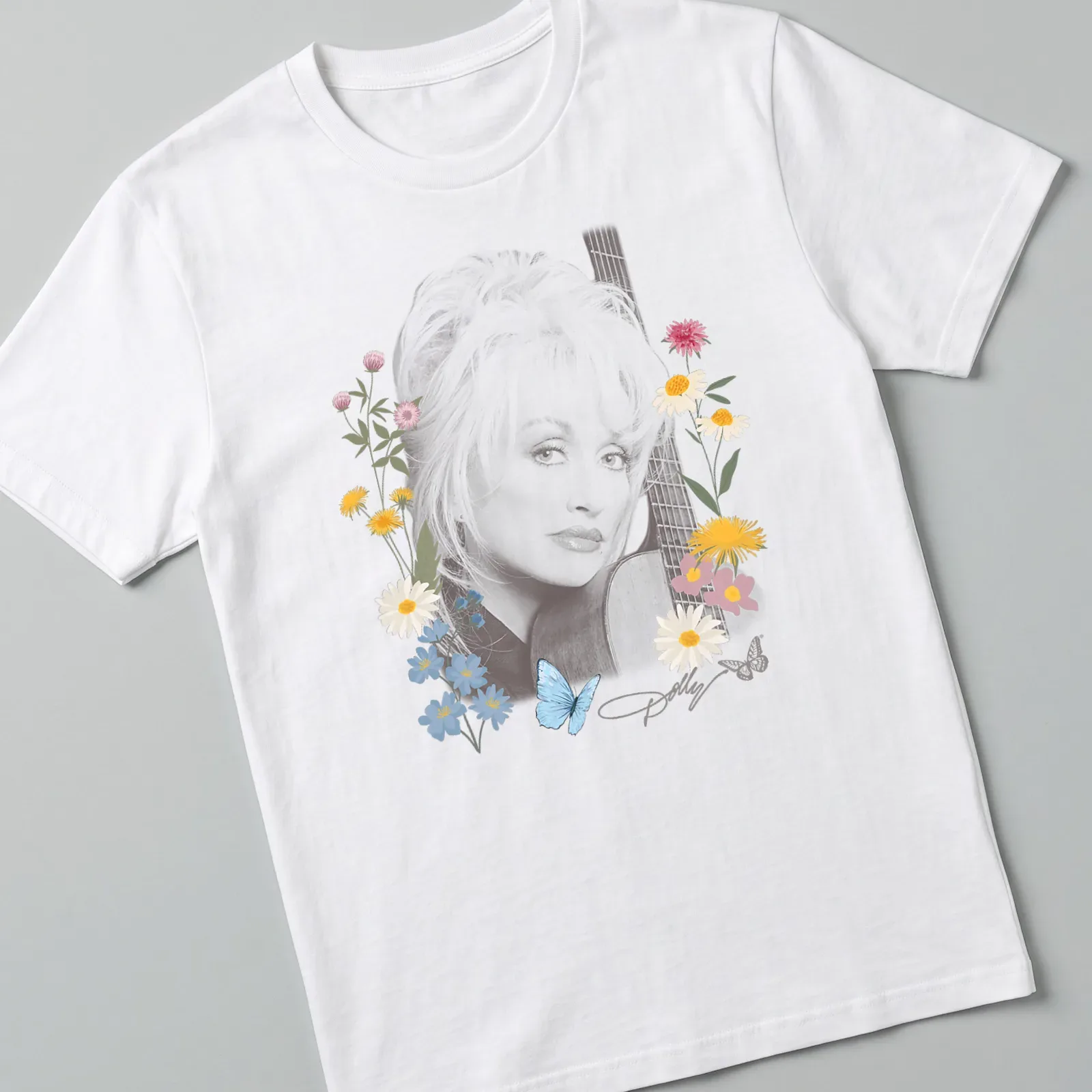 Floral portrait of Dolly Parton with butterflies in pastel colors — printed on a unisex t-shirt