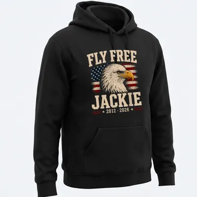 Eagle design with vintage distressed text 'Fly Free Jackie 2012 - 2026' on American flag background — printed on a unisex hoodie