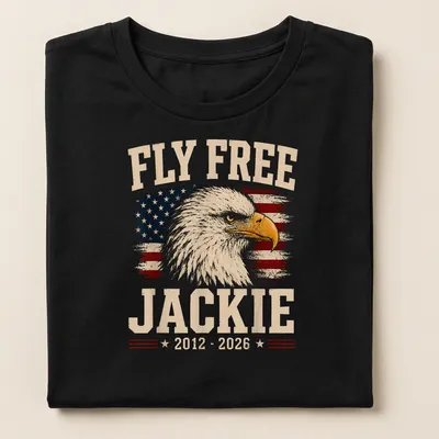 Eagle design with vintage distressed text 'Fly Free Jackie 2012 - 2026' on American flag background — printed on a women's shirt