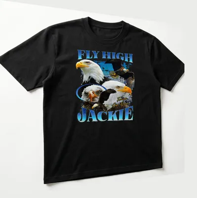 Bald Eagle in flight with text 'FLY HIGH JACKIE Forever Our Queen' beneath — printed on a unisex t-shirt (angled view)