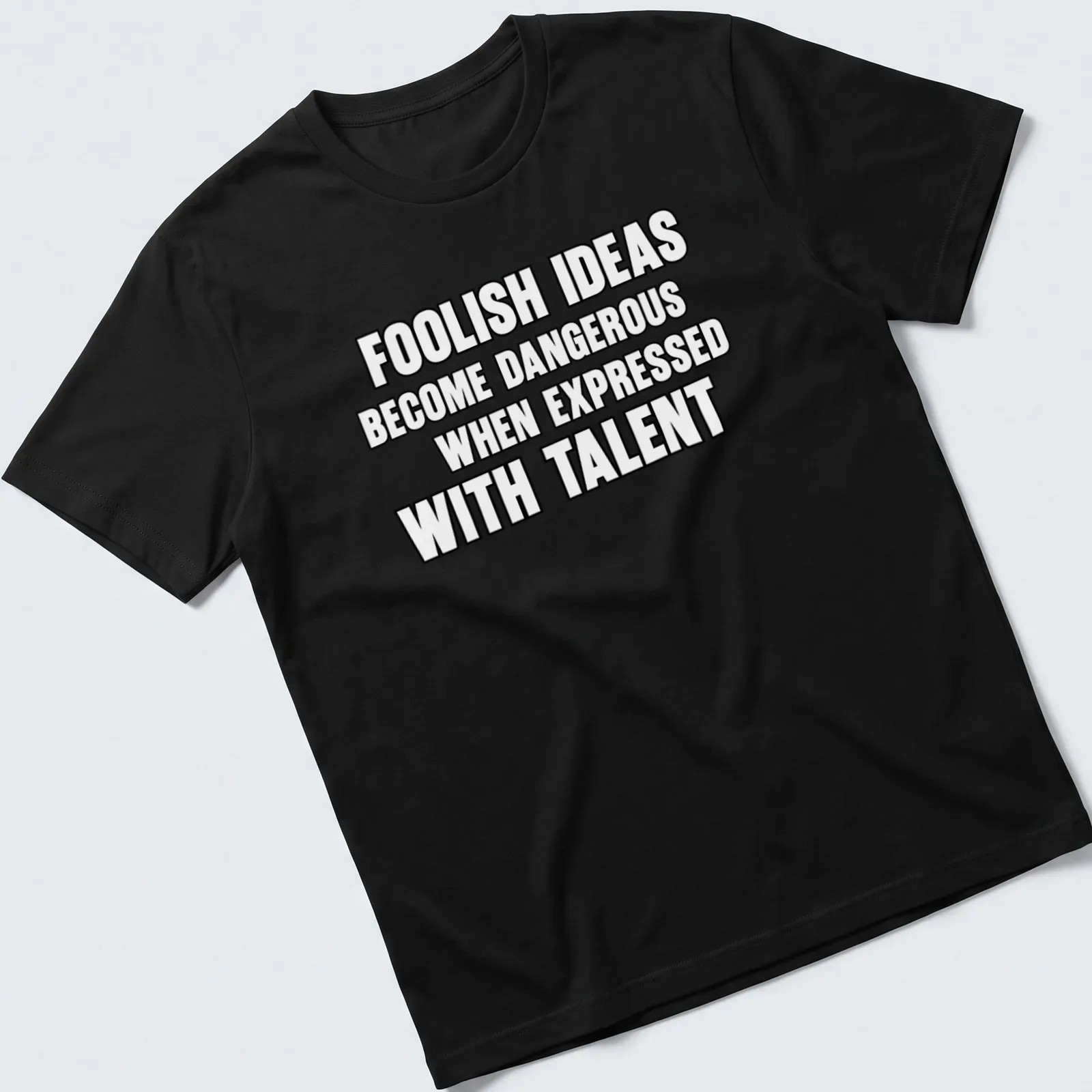 Bold typography t-shirt displaying the phrase about foolish ideas and talent. — printed on a unisex t-shirt