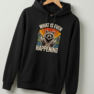 Cartoon raccoon with puzzled expression next to vintage text, 'WHAT IS EVEN HAPPENING'. — printed on a unisex hoodie