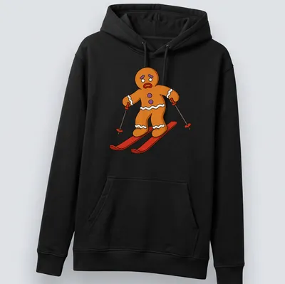 Cartoon gingerbread man skiing with red scarf against colorful background — printed on a unisex hoodie