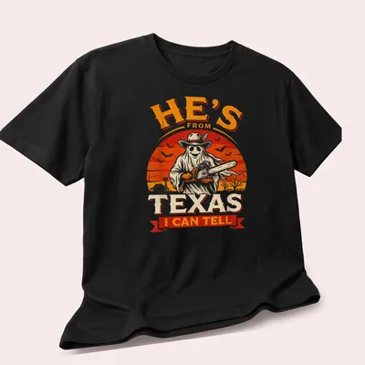 Vintage horror shirt with chainsaw ghost and Texan phrase in bold text — printed on a unisex t-shirt (angled view)