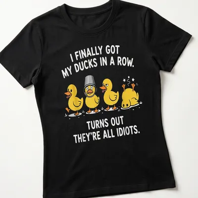 Playful cartoon ducks with humorous text about disorganization on a — printed on a women's shirt