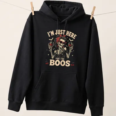 Vintage retro t-shirt featuring a skeleton holding wine glasses with Halloween-themed text — printed on a unisex hoodie