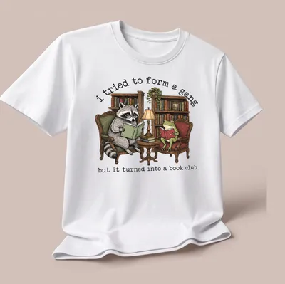 Vintage illustration of a raccoon and frog reading books with humorous text — printed on a unisex t-shirt (angled view)