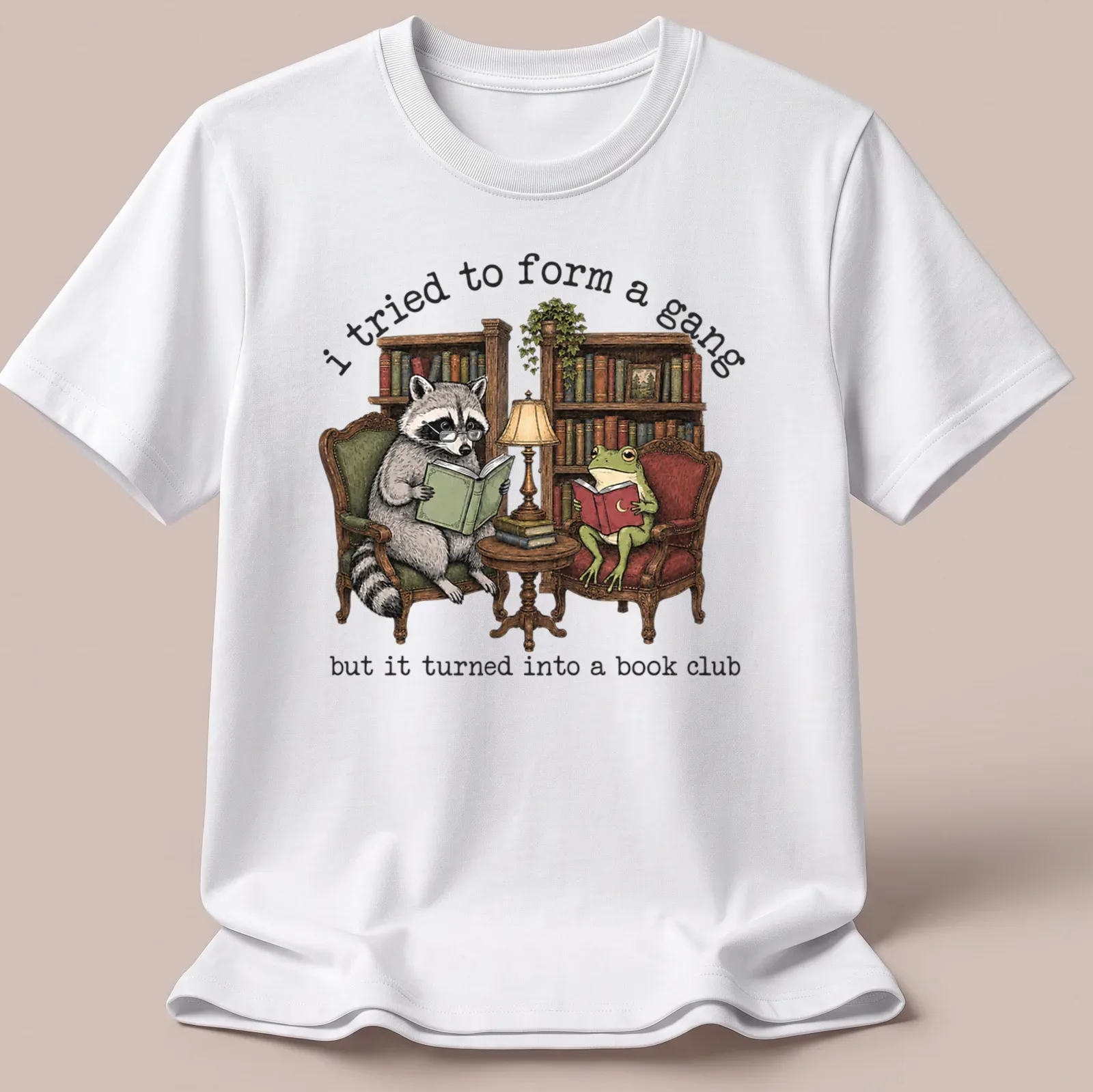 Vintage illustration of a raccoon and frog reading books with humorous text — printed on a unisex t-shirt