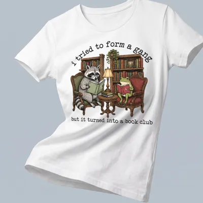 Vintage illustration of a raccoon and frog reading books with humorous text — printed on a women's shirt