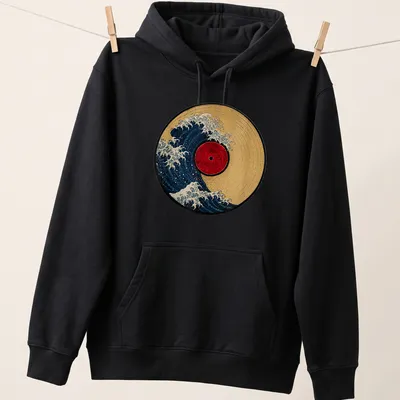 Retro design of a wave crashing over a vinyl record in blue, red, and gold — printed on a unisex hoodie