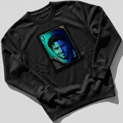 Vibrant illustration of the Joker playing card face featuring the letter J — printed on a unisex sweatshirt
