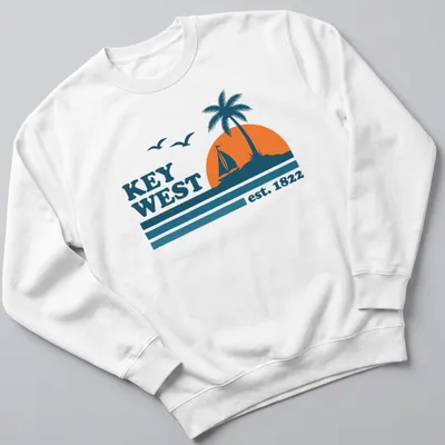 Vintage retro Key West T-shirt with sailboat and palm tree graphic — printed on a unisex sweatshirt