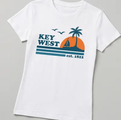 Vintage retro Key West T-shirt with sailboat and palm tree graphic — printed on a women's shirt