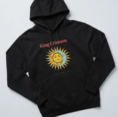Vintage T-shirt featuring King Crimson artwork with sun and moon faces in bold colors. — printed on a unisex hoodie