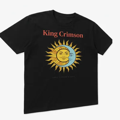 Vintage T-shirt featuring King Crimson artwork with sun and moon faces in bold colors. — printed on a unisex t-shirt (angled view)