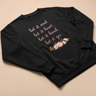 Pastel floral design with the phrase 'let it end. let it hurt. let it heal. let it go.' — printed on a unisex sweatshirt
