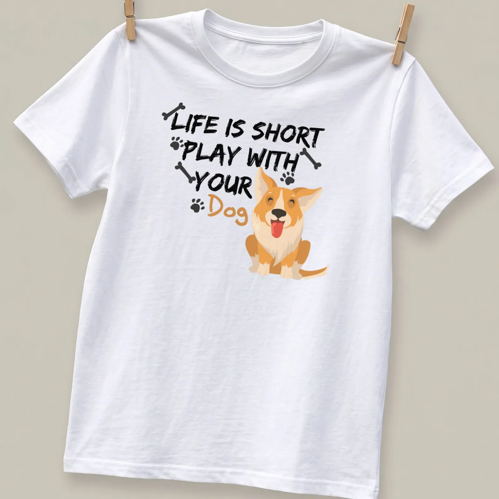 Cute cartoon Corgi with the phrase 'Life Is Short Play With Your Dog' printed above — printed on a unisex t-shirt