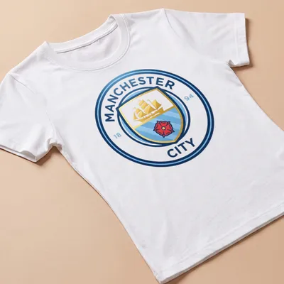 Manchester City crest t-shirt with emblem design in blue, gold, red, and white — printed on a women's shirt