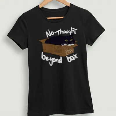Whimsical illustration of a black cat in a cardboard box with playful text — printed on a women's shirt