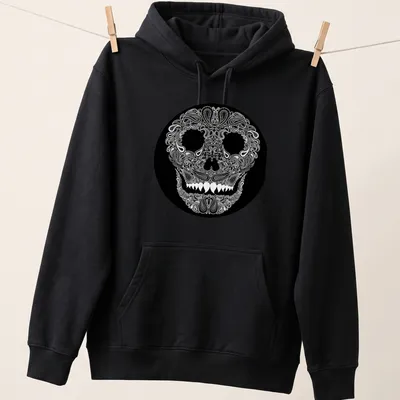 Skull design with paisley pattern in white on a black background — printed on a unisex hoodie