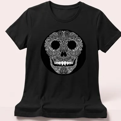 Skull design with paisley pattern in white on a black background — printed on a women's shirt
