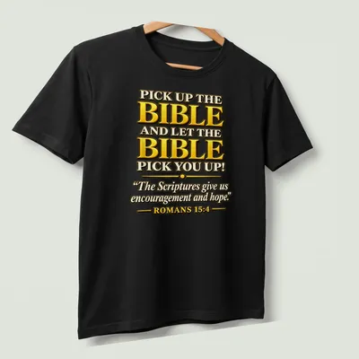 Bold decorative typography featuring Bible verse in gold, black, and white — printed on a unisex t-shirt (angled view)