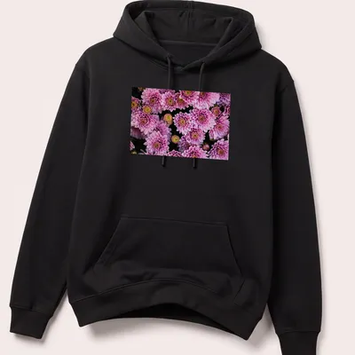 Photographic floral design featuring pink chrysanthemums with green leaves — printed on a unisex hoodie