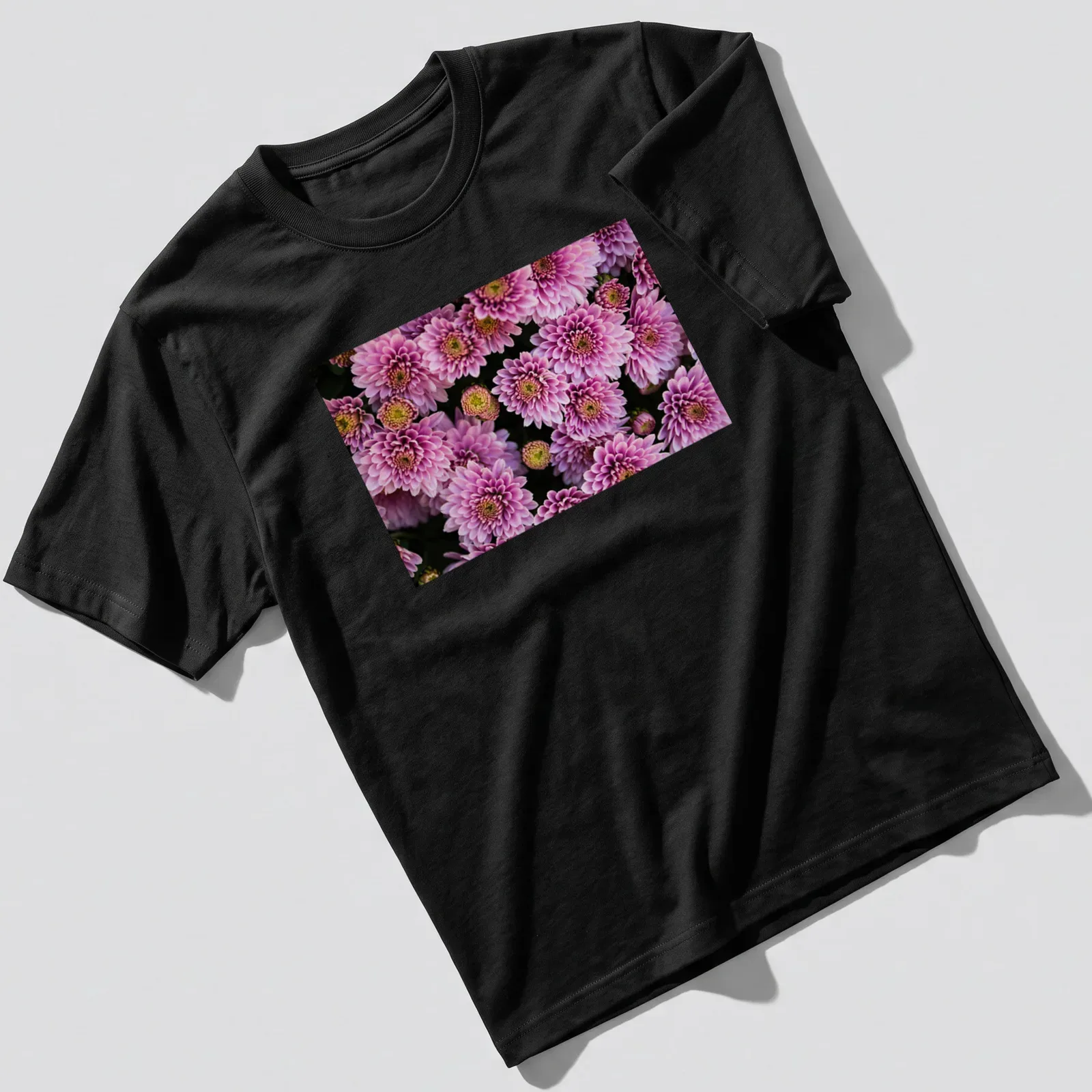 Photographic floral design featuring pink chrysanthemums with green leaves — printed on a unisex t-shirt