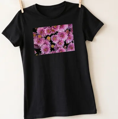 Photographic floral design featuring pink chrysanthemums with green leaves — printed on a women's shirt