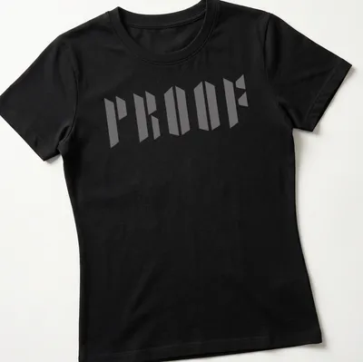 Bold gray typography shirt with the word PROOF in geometric design — printed on a women's shirt