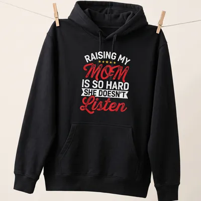 Bold retro text design saying 'Raising My Mom Is So Hard She Doesn't Listen' in red, white, and yellow. — printed on a unisex hoodie