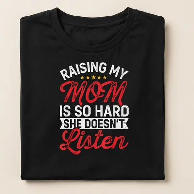 Bold retro text design saying 'Raising My Mom Is So Hard She Doesn't Listen' in red, white, and yellow. — printed on a women's shirt