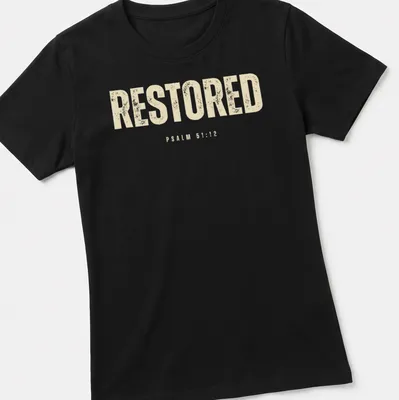 Bold distressed Christian shirt featuring the text RESTORED PSALM 51:12. — printed on a women's shirt