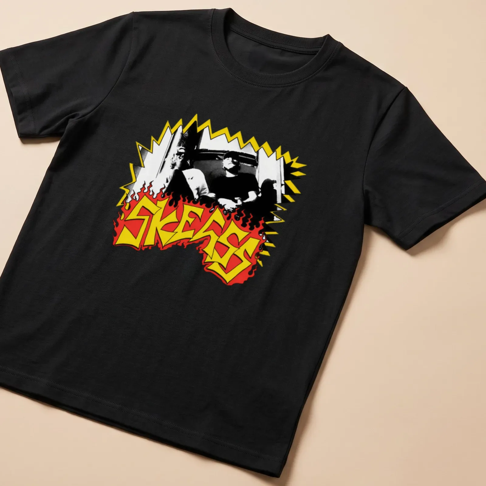 Bold graphic SKEGSS band logo in black, yellow, and red. — printed on a unisex t-shirt